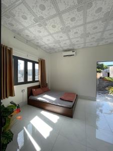 a bedroom with a bed and a coffered ceiling at Town Homestay in Thôn Sơn Hải