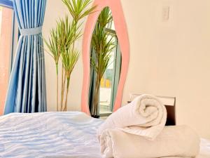 a bedroom with a bed and a pink mirror at The Sun Avenue - TPHomes in Ho Chi Minh City +22 photos