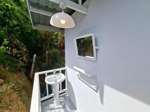 a bathroom with a sink and a tv on the wall at Sleep On The Clouds in Ban Kata
