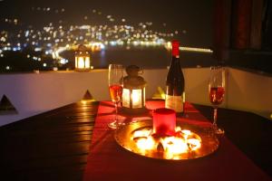 a table with a bottle of wine and two glasses at Irene' s Paradise in Skopelos Town