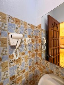 a bathroom with a toilet and a mirror at The Ivory Castle in Pooc +105 photos