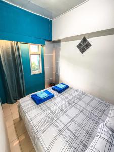 a bedroom with a bed with two blue towels on it at Pintu Biru Hostel in Wamena +174 photos