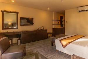 a hotel room with a bed and a desk at Boracay Sands Hotel in Boracay