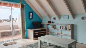 a living room with a table and a book shelf at Anchorage in Stompneusbaai