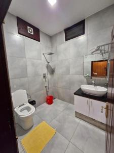 a bathroom with a toilet and a sink at The Boho Inn in Cochin