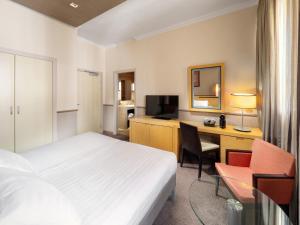 a hotel room with a bed and a desk at Mamaison Hotel Andrassy Budapest in Budapest +77 photos