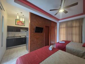a hotel room with two beds and a kitchen at Hotel y Suites Los Encantos in Sayulita