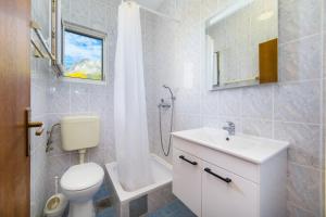 a bathroom with a toilet and a sink and a shower at Apartmani More in Gradac +58 photos