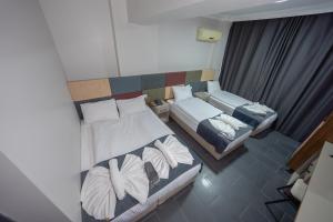 a small bedroom with two beds and a window at diamond premium hotel in Istanbul
