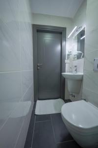 a white bathroom with a toilet and a sink at diamond premium hotel in Istanbul