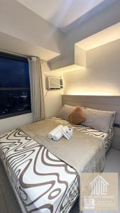 a hotel room with a zebra print bed with two towels at Horizons 101 Studio unit near Fuente in Cebu City