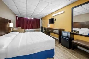 a hotel room with a large bed and a desk at Econo Lodge Gretna - New Orleans in Gretna