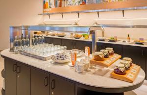 a buffet line with different types of food on display at Spark by Hilton Wuppertal City Centre in Wuppertal