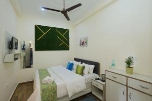 a bedroom with a bed and a ceiling fan at Hotel Pi-Tapovan in Rishīkesh