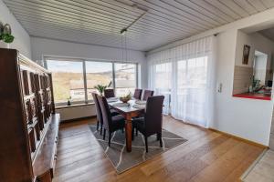 a dining room with a table and chairs at Ferienhaus Waldzeit in Heimbach