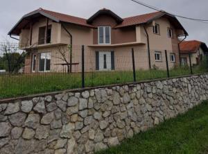 a stone wall in front of a house at Apartment Freya in Zadoborje