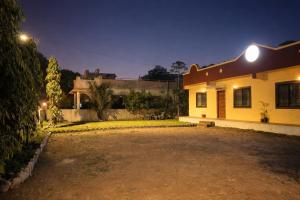 a house with a driveway in the night at The Calm Courtyard- Pune in Pune +7 photos