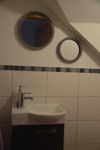 a bathroom with a sink and two mirrors at Ferienwohnung Sigrid in Forchheim