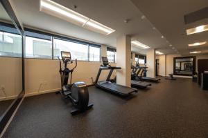 a gym with several treadmills and elliptical machines at DoubleTree by Hilton Hotel Houston Hobby Airport in Houston