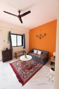 a living room with a couch and a table at The Calm Courtyard- Pune in Pune