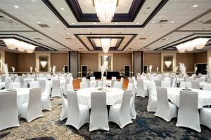 a banquet hall with white tables and chairs at DoubleTree by Hilton Hotel Houston Hobby Airport in Houston +35 photos