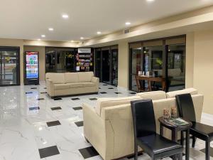 a lobby with couches and a table and chairs at Comfort Suites Kings Bay Naval Base Area in Kingsland