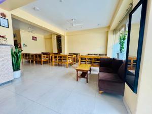 an empty waiting room with tables and chairs at Namaste Guest House in Pokhara