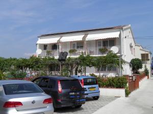 a group of cars parked in front of a building at Adria Sun Apartments in Vodice