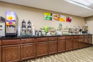 a kitchen with a counter with food on it at Quality Suites Graham - Burlington South in Graham