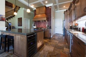a large kitchen with wooden cabinets and a large island at OKeefes Landing Bed & Breakfast in Vernon