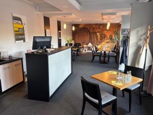 a restaurant with tables and chairs and a bar at BeskidPark in Bielsko-Biała