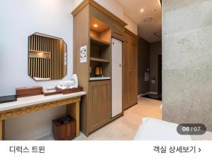a bathroom with a sink and a mirror on the wall at 호텔뷰 in Tomin-dong