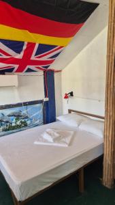 a bed in a room with a flag on the ceiling at Lucy's Diner Hostel Cafe in San Francisco