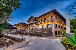 an exterior view of a house with lights on it at Amrutham Bagh Resort & Spa in Udaipur