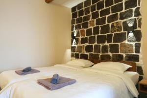 a bedroom with two beds with towels on them at Castle Gyumri in Gyumri