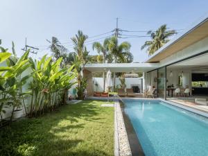 an image of the backyard of a house with a swimming pool at Calypso Villa Phuket - Naiyang Beach in Nai Yang Beach