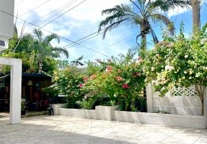 a bunch of flowers on a white fence at Casa Flores in Sampong