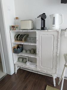 a white shelf with some appliances on top of it at Beach Avenue Suite in Apúlia