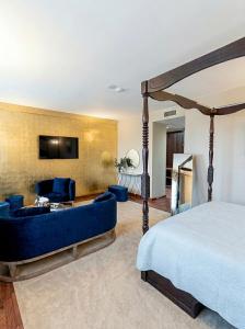 a bedroom with a bed and a couch and a tv at Hotel Castillo Bonavía in Pedrola