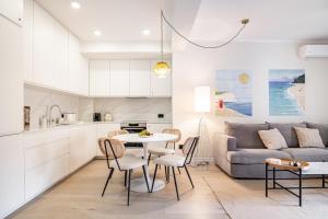 a kitchen and living room with a table and chairs at Dimitris Residence in Tivat
