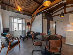a living room with a table and chairs at Lovely, modern, 4-person apartment in the heart of Koudekerke in Koudekerke +145 photos