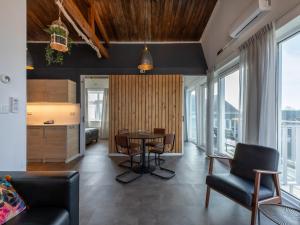 a kitchen and living room with a table and chairs at Lovely, modern, 4-person apartment in the heart of Koudekerke in Koudekerke