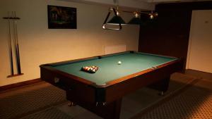a pool table with a ball in a room at Hotel Plinkšių in Plinkšės