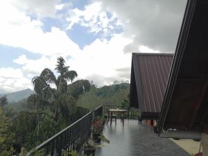 a balcony with a table and a view of a mountain at The Cliff Lodge Ella in Ella