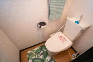 a bathroom with a toilet with a sticker on it at マンションルミエールＩ301 rumiereＩ301 in Gifu +15 photos
