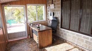 a home office with a desk and a window at Burj Resort in Ban