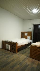 a bedroom with two beds in a room at Burj Resort in Ban