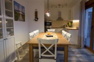 a kitchen and dining room with a wooden table and chairs at Jezerska Villa in Ogulin