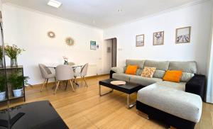 a living room with a couch and a table at NEXTHOME Beach & Pool in Lloret de Mar