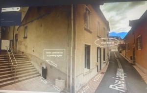 an empty street with signs on the side of a building at Appartement Kylie in Néris-les-Bains